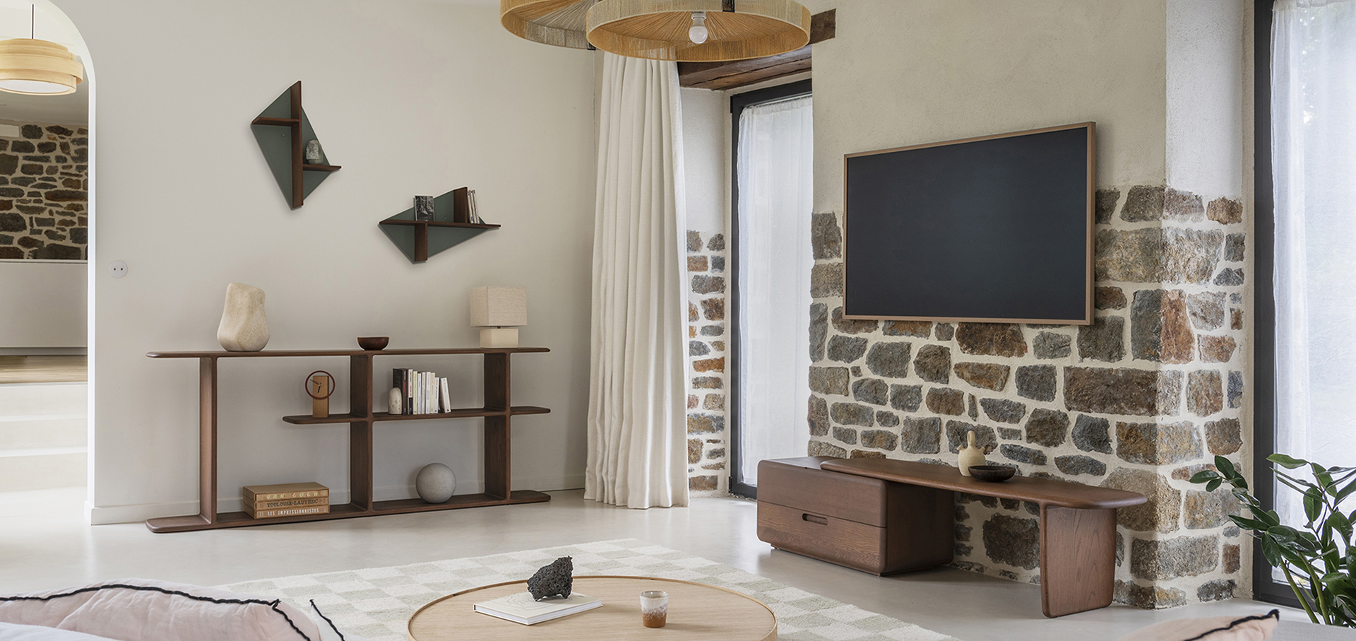 salon salle de séjour campagnard pierre apparente design arrondi meubles bois massif teinte noyer